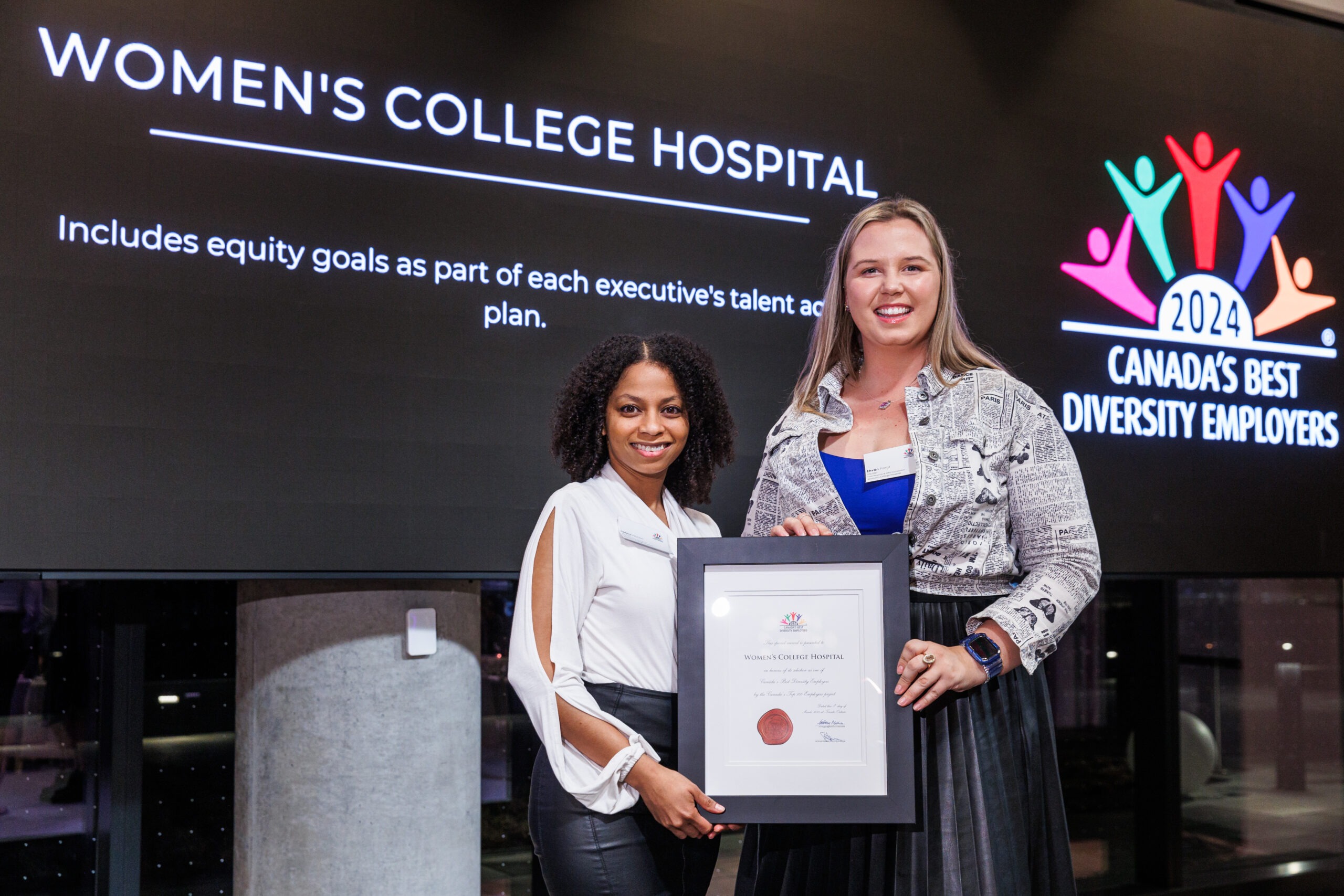 Two Women's College Hospital employees accepting Canada's Best Diversity Employers 2024 Award