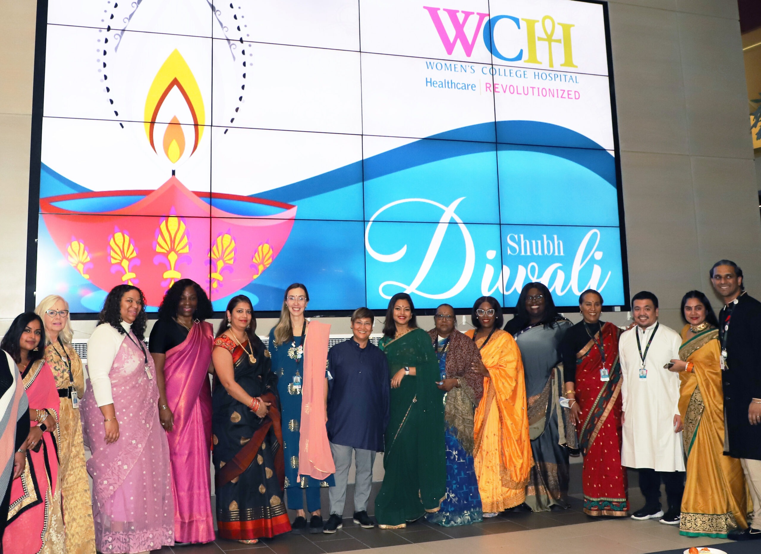 WCH staff dressed in saris celebrating Diwali standing alongside each other smiling 