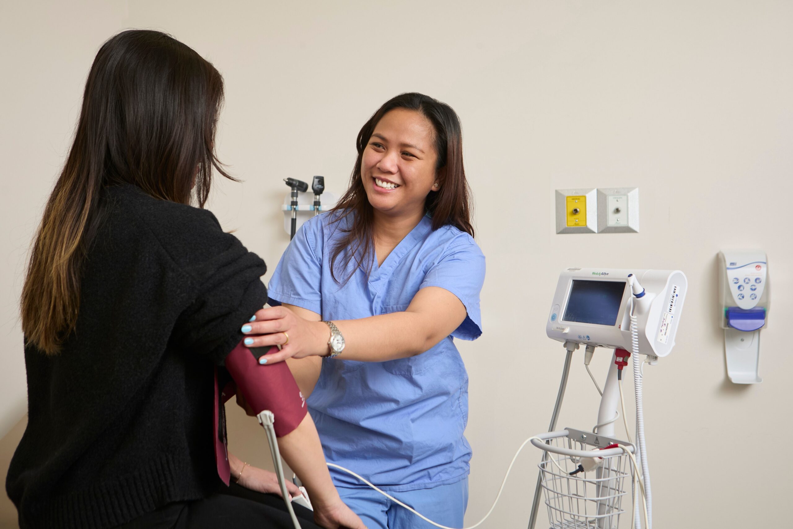 Eunice Cauzo (nurse) taking patient's blood pressure