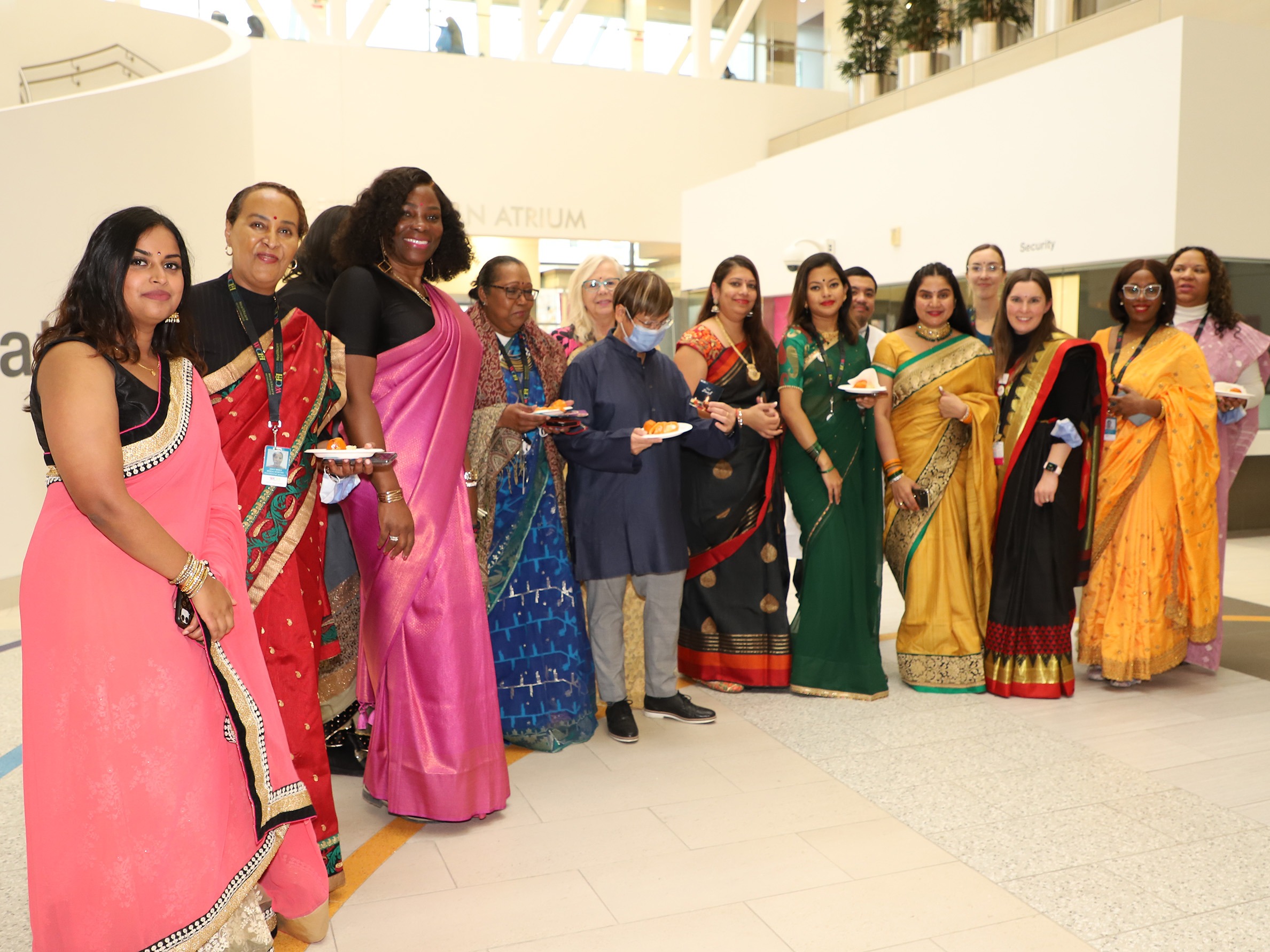 Group photo of WCH staff wearing saris smiling